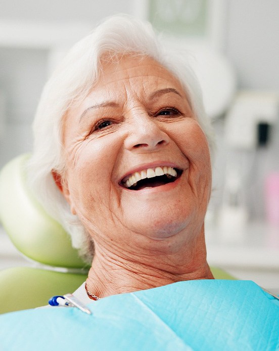 A woman smiling at the dentist