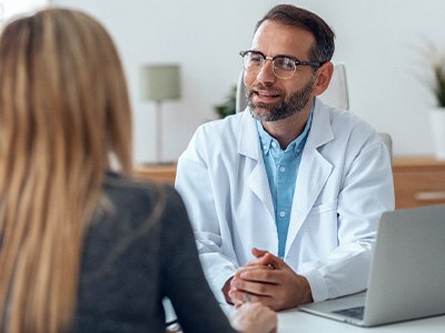 dentist talking to patient about dental implants