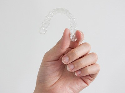Patient holding clear aligner