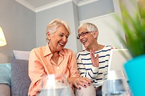Two women talking on a couch