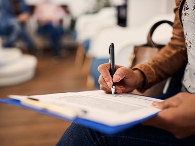 Patient filling out paperwork in lobby
