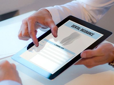 Patient reviewing dental insurance forms on tablet