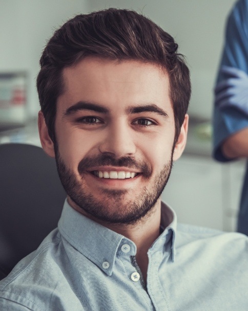 Smiling man sitting in Mesquite dental office