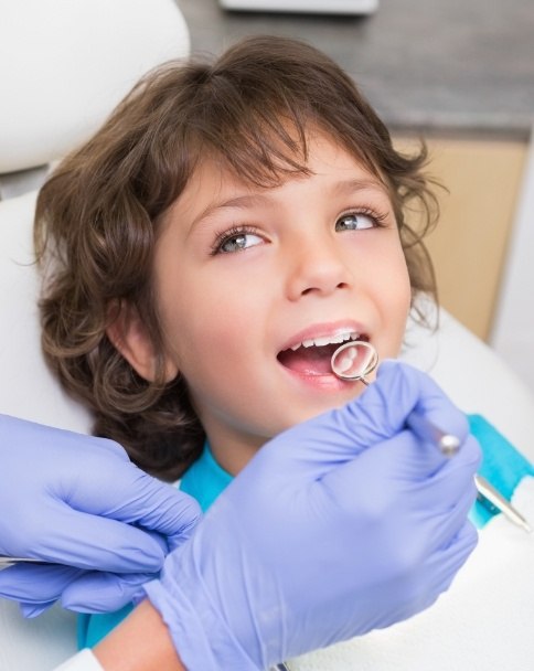 Child smiling during dental checkup for kids in Mesquite