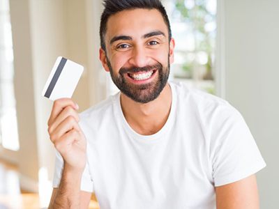 Smiling man holding a payment card