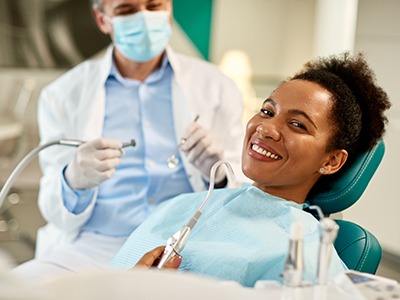 Smiling woman relaxing in dentist's treatment chair