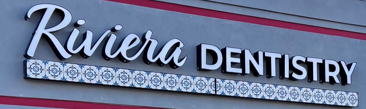 Sign on building for Riviera Family Dentistry in Mesquite