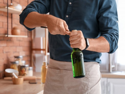 Man opens bottle with opener