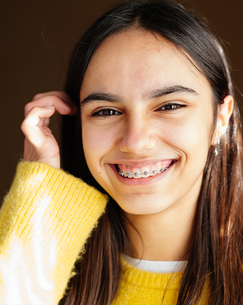 Smiling teenage girl with traditional braces in Mesquite