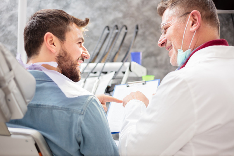 Patient talking to dentist about getting a dental implant